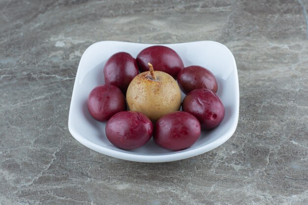 Close up photo of palms with apple in bowl . 