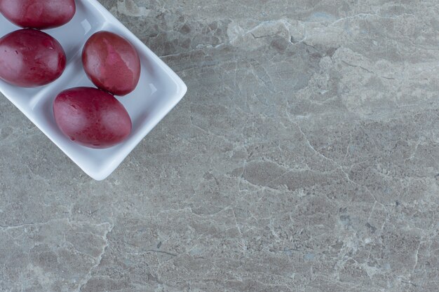 Close up photo of Pickled palm on white plate over grey background. 