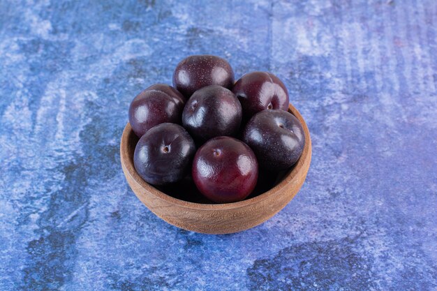 Close up photo of pile of berries in wooden board.