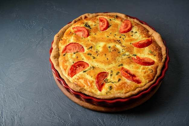 Close-up photo of quiche lorraine pie with tomatoes