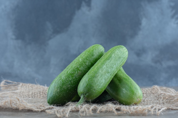 Close up photo of stack of green organic cucumber .