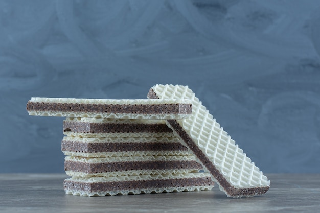 Close up photo of stack of wafers on grey table.