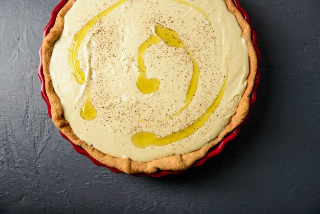 Close-up photo of tart with cream and olive oil
