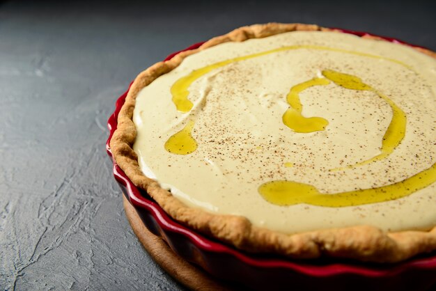 Close-up photo of tart with dough and olive oil