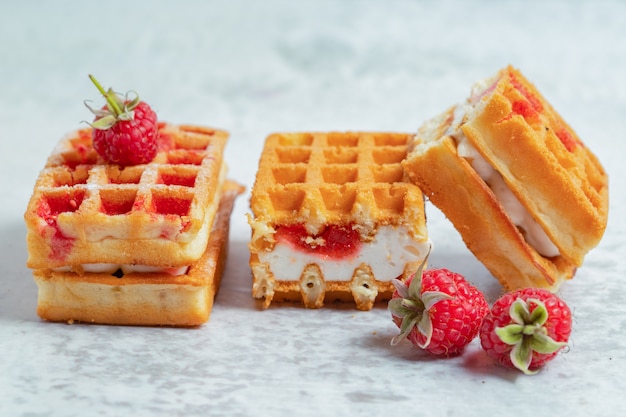 Close up photo of three waffle slice on grey surface