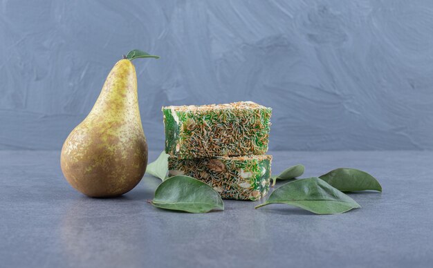 Close up photo of Turkish delight rahat lokum with hazelnuts on grey background.