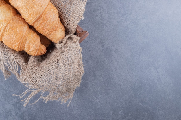 Close up photo of two freshly baked French croissant.