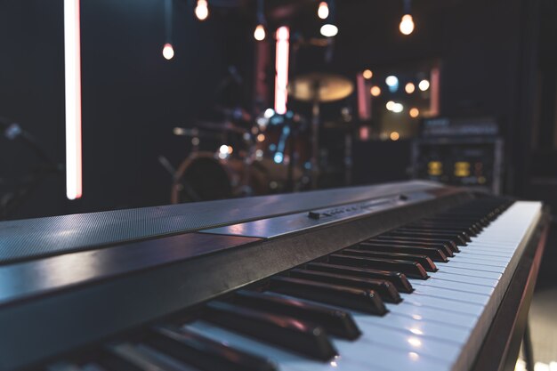 Close up of piano keys on blurred background with bokeh.