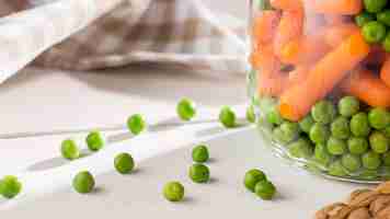Free photo close-up of pickled peas and baby carrots in jars
