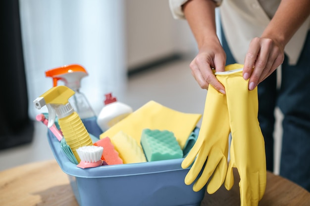 Close up picture of female hands taking on gloves