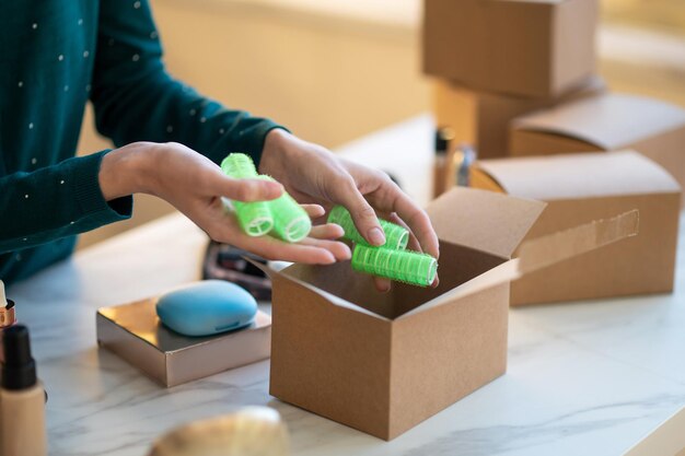 Close up picture of females hands holding curlers