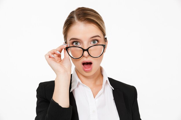 Close up picture of Surprised blonde business woman in eyeglasses with open mouth over white