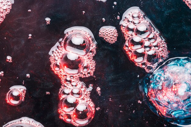 Close-up pink bubbles on dirty water