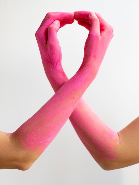 Close-up pink painted arms expressing awareness