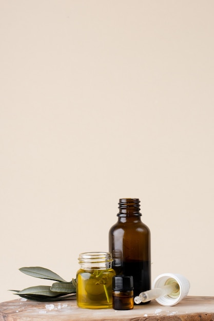 Close-up plastic bottle with oil and rosemary