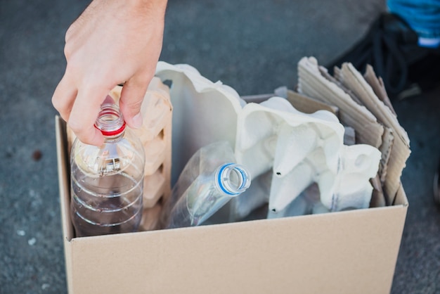 Close-up of plastic bottles and egg carton in the box