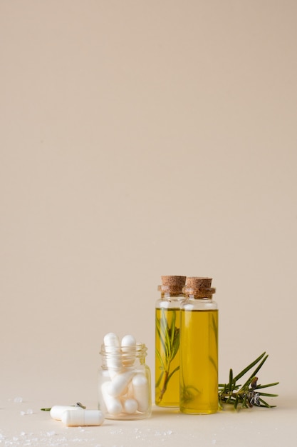 Close-up plastic bottles with oil and rosemary