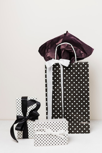 Close-up of polka dotted gift boxed and paper bag