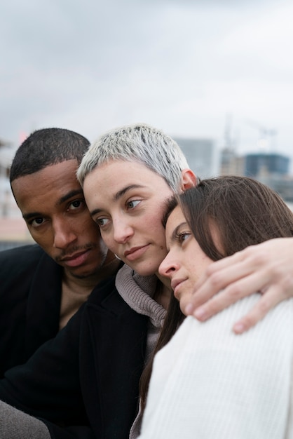 Close up polyamorous partners hugging