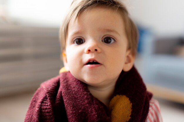 Close-up portrait of adorable baby at home