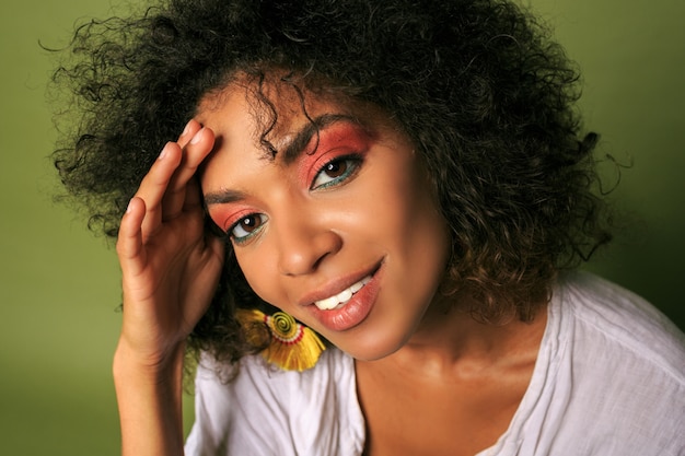 Free photo close up portrait of african woman with bright colourful; make up posing