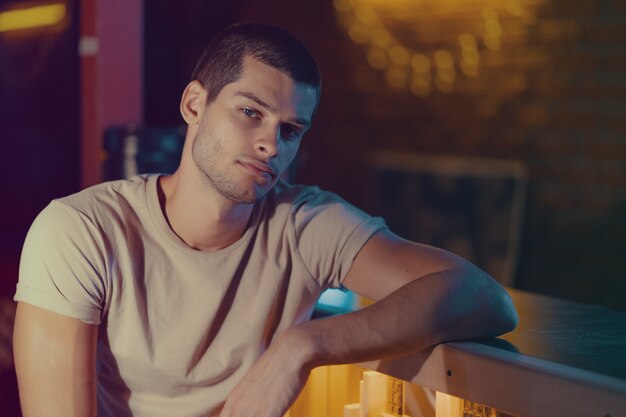 Close-up portrait of attractive male model. Young handsome man in a bar