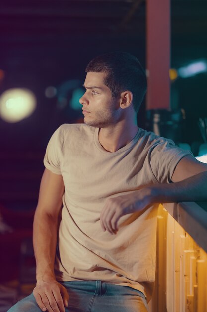 Close-up portrait of attractive male model. Young handsome man in a bar