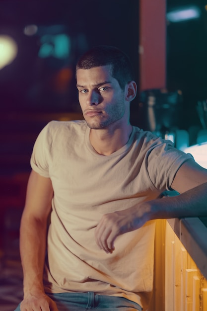 Close-up portrait of attractive male model. Young handsome man in a bar