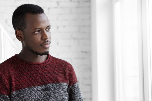 Close up portrait of attractive young dark-skinned designer having rest