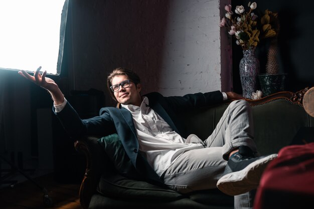 Close-up portrait of an attractive young man relaxing on the couch