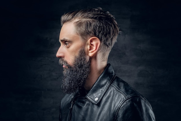 Close up portrait of bearded male wearing black leather jacket.