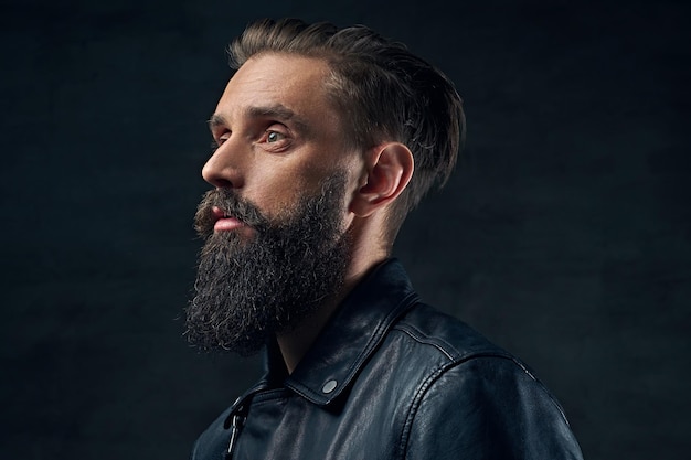 Close up portrait of bearded male wearing black leather jacket.