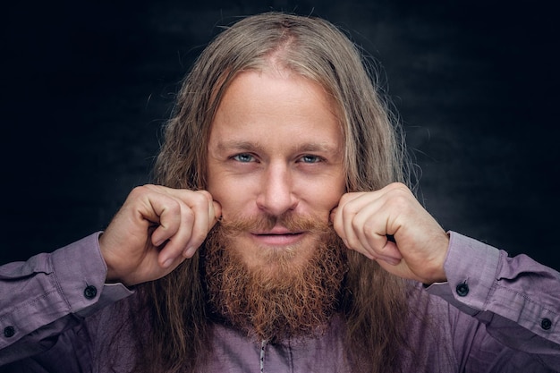 Close up portrait of bearded male with long hair.