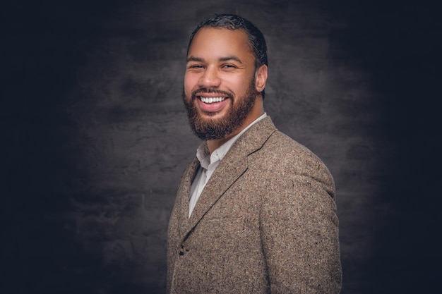 Close up portrait of bearded smiling black man in a wool suit.