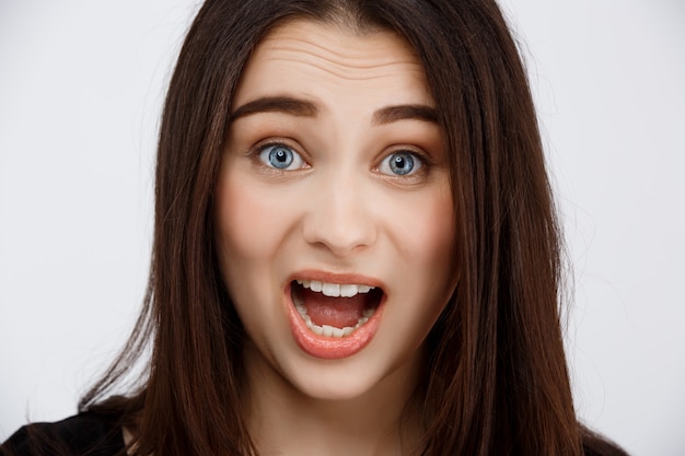 Close up portrait of beautiful surprised brunette girl 