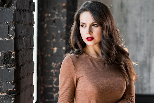 Close-up portrait of a beautiful young woman looking away