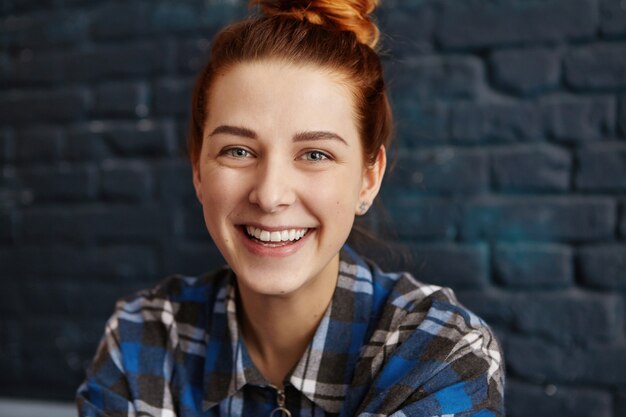 Close up portrait of beautiful young woman with ginger hair and clean healthy skin