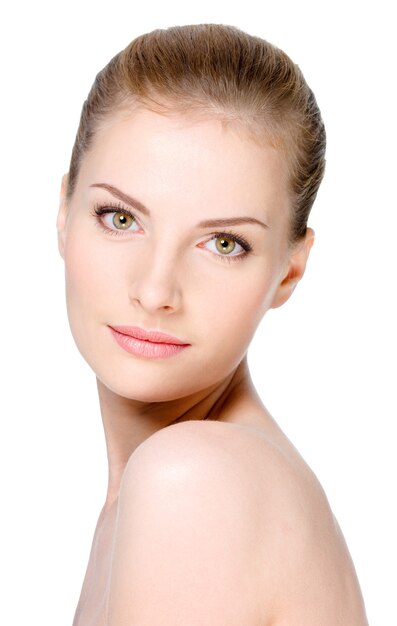 Close-up portrait of beautiful young woman with healthy clean skin on a face - isolated