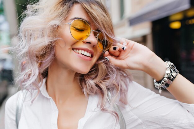 Close-up portrait of blonde romantic lady in trendy jewelry posing