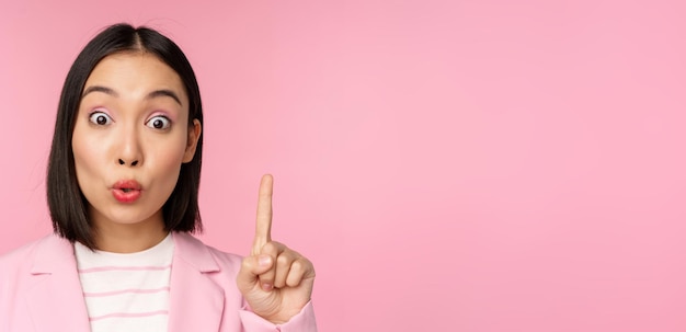 Free photo close up portrait of businesswoman raising finger up suggesting got an idea or solution standing ove