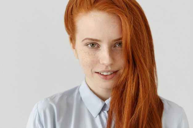 Close up portrait of charming young Caucasian woman with freckles