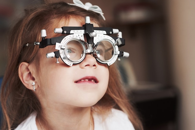 Close up portrait of child in special glasses that watching to the right.