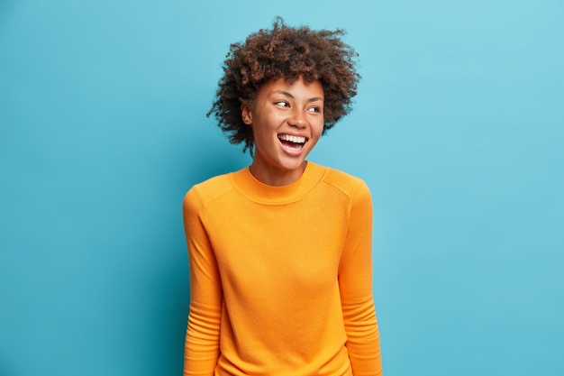 Close up portrait of curly haired young woman isolated