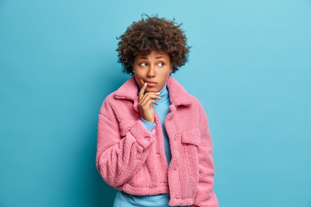 Close up portrait of curly haired young woman isolated