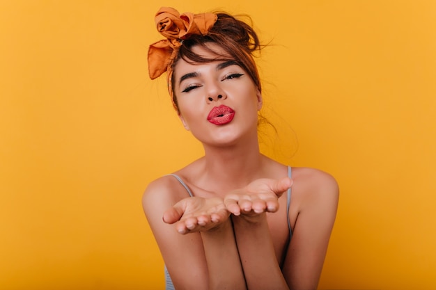 Close-up portrait of cute tanned female model with lovely face