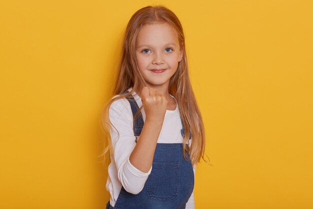 CLose up portrait of displeased angry female child with long blond hair