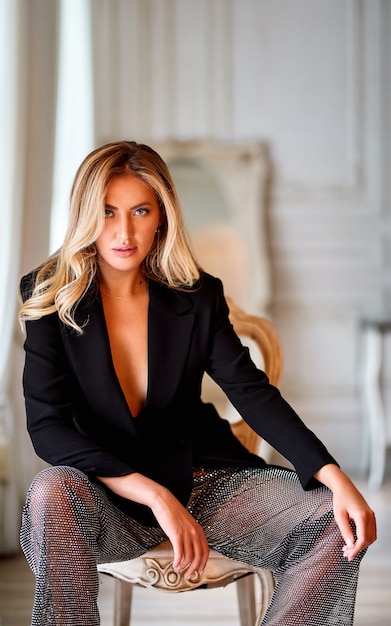 Close-up portrait of elegant woman.Blonde woman with curly beautiful hair. Beautiful blonde long curly hair woman with beauty makeup and healthy skin female fashion portrait.