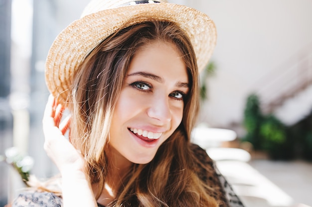 Close-up portrait of excited girl with pale skin and big gray eyes happy posing