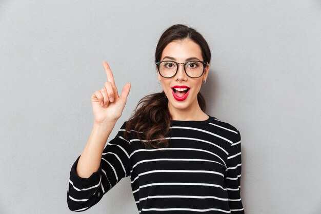 Close up portrait of an excited woman in eyeglasses