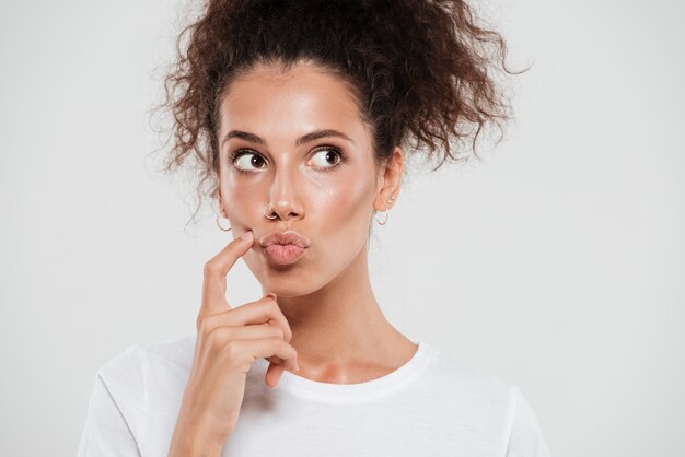 Close up portrait of a funny girl curly hair thinking